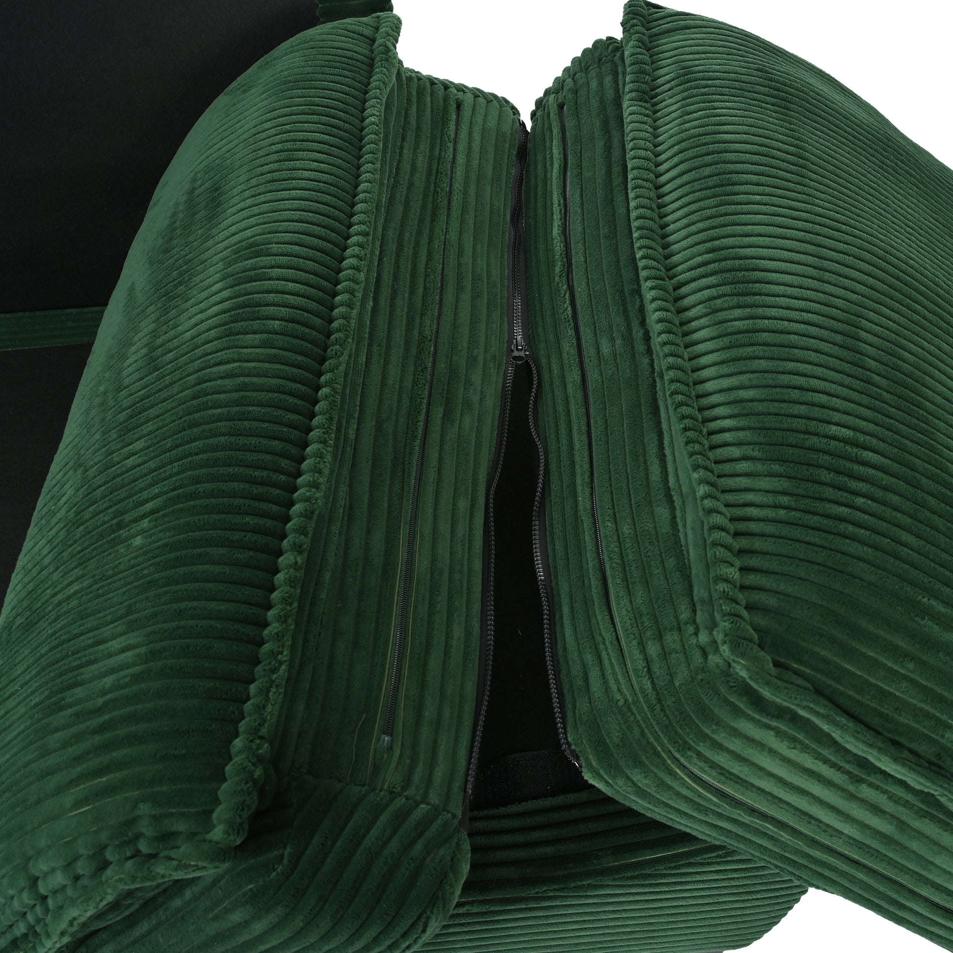 Deep green corduroy pillow with visible zipper closure and plush texture