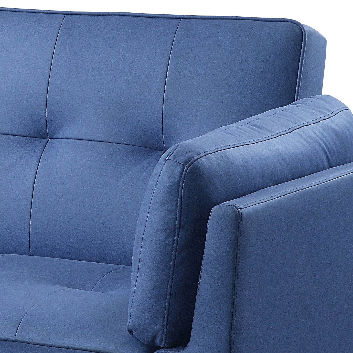 Deep blue fabric sofa armrest detail with stitched tufting and piped edges