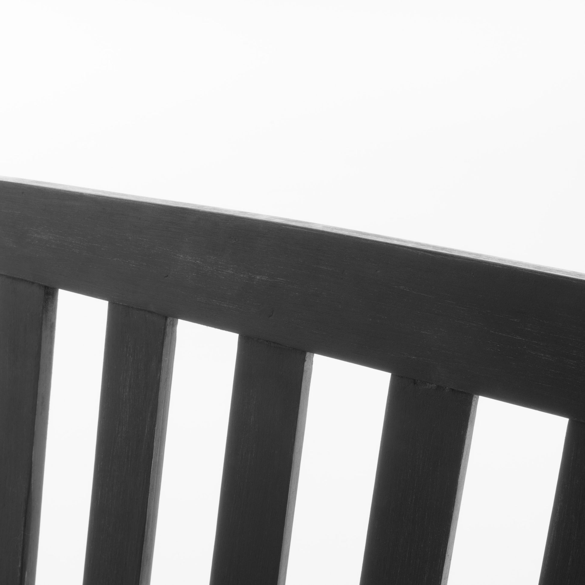 Closeup of a dark wood slatted backrest on a garden bench