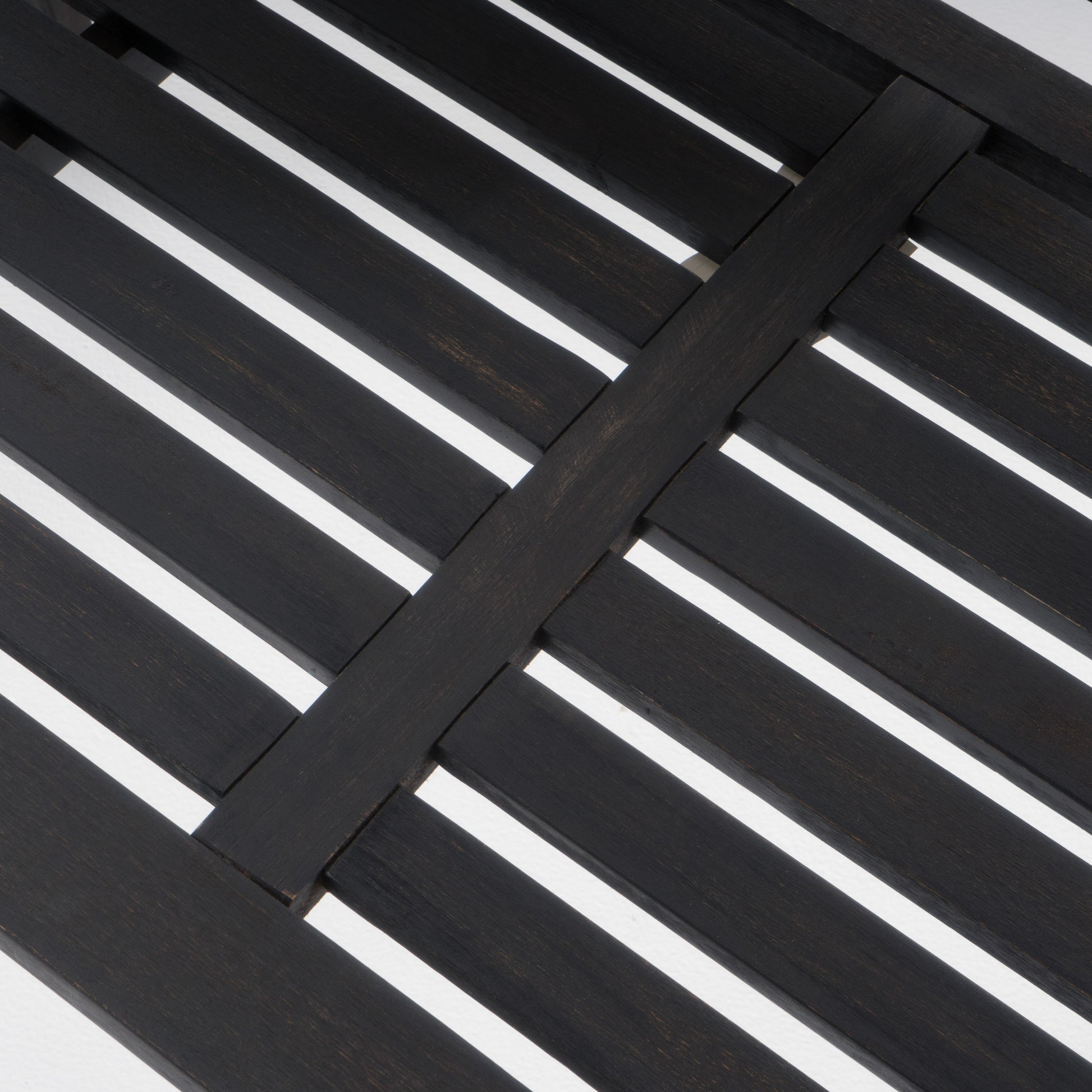 Dark wood slatted tabletop with intersecting planks