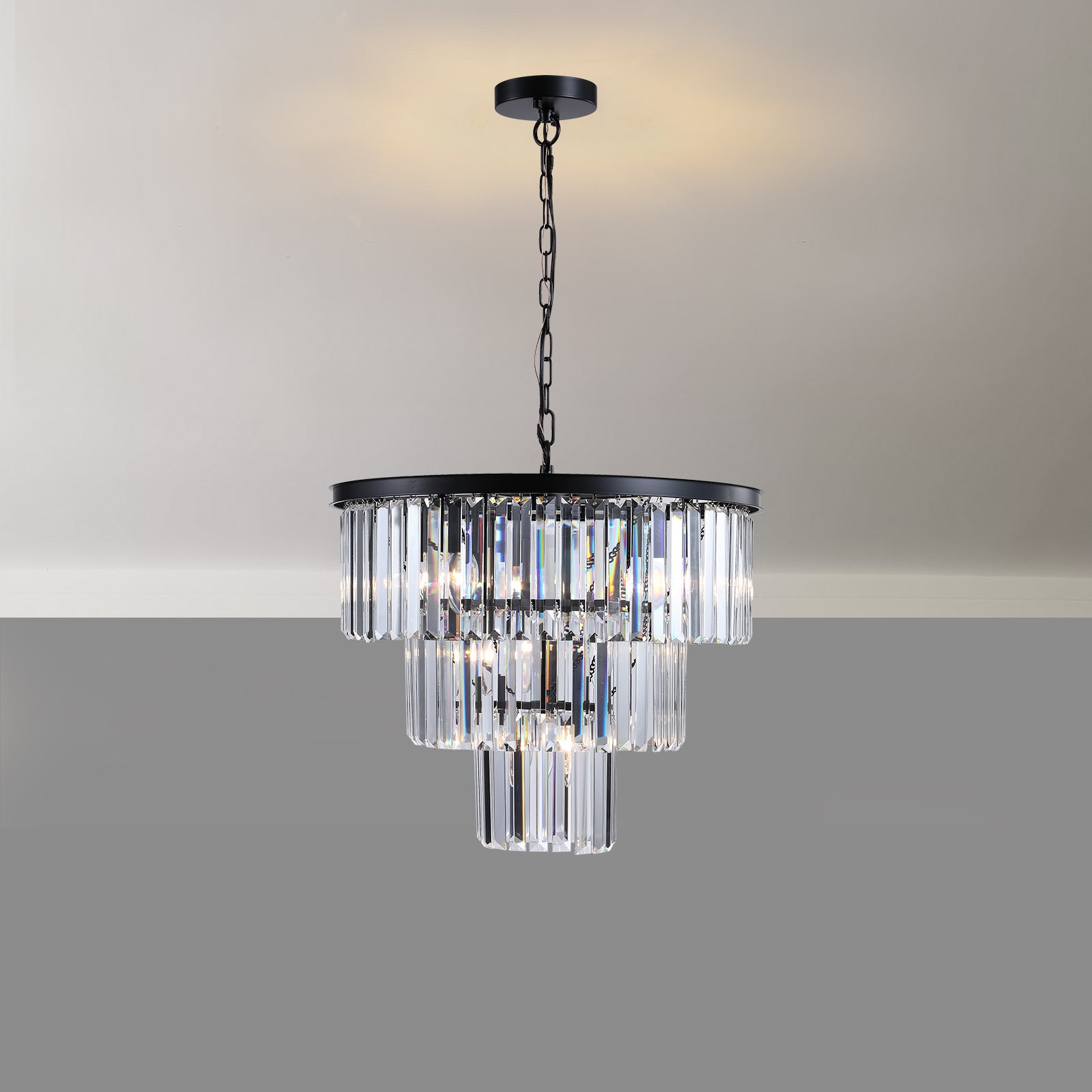 Elegant tiered crystal chandelier with a black metal frame illuminating a dining room