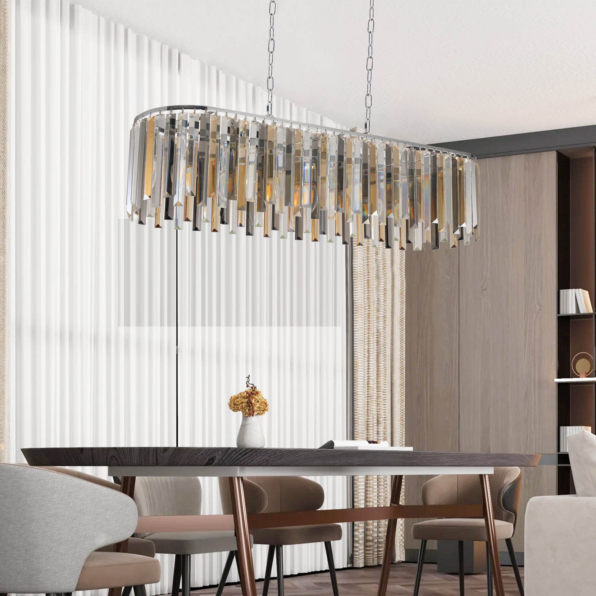 Rectangular crystal chandelier with chrome accents and cascading prisms over dining table