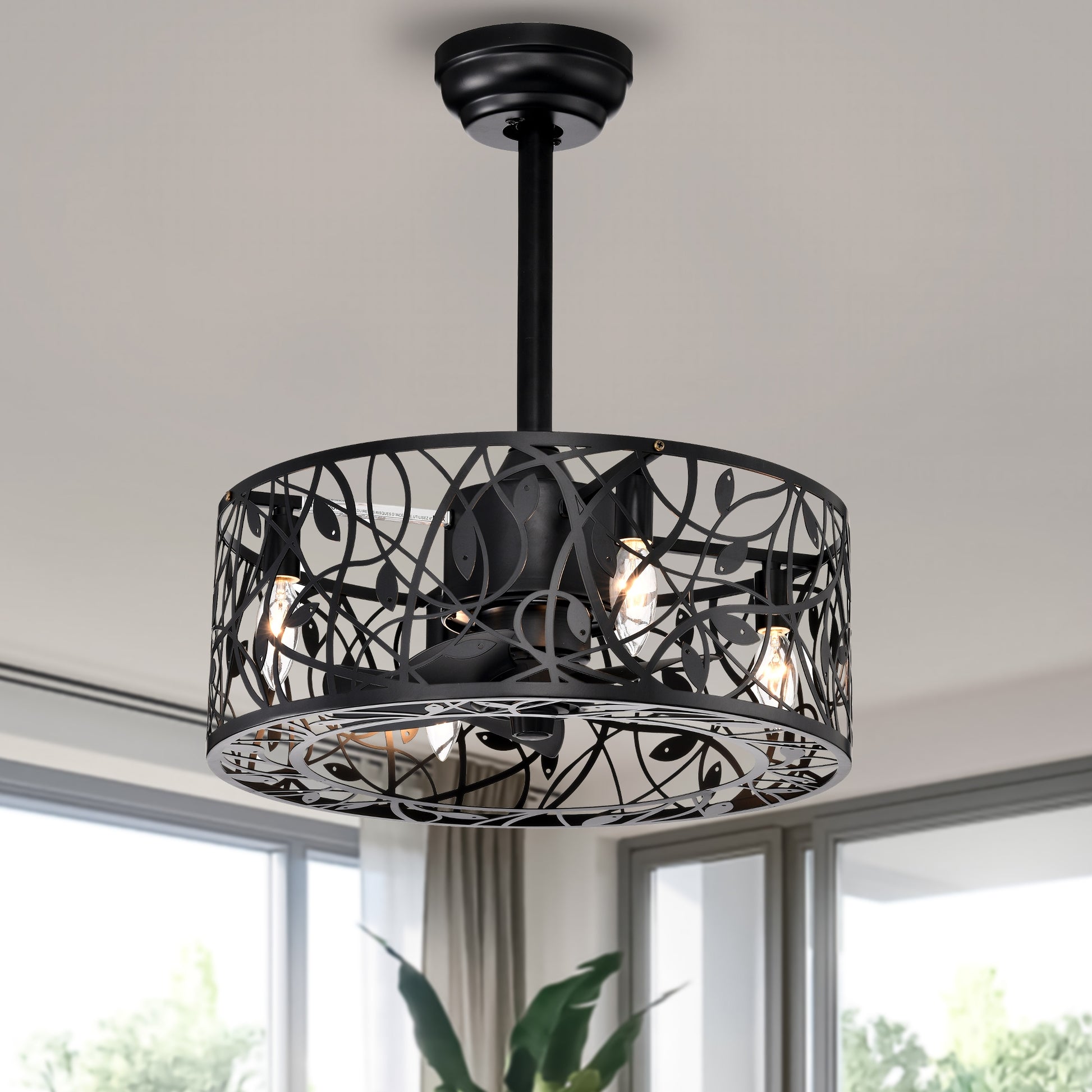 Black modern ceiling fan with intricate leaf design metal shade and visible bulbs