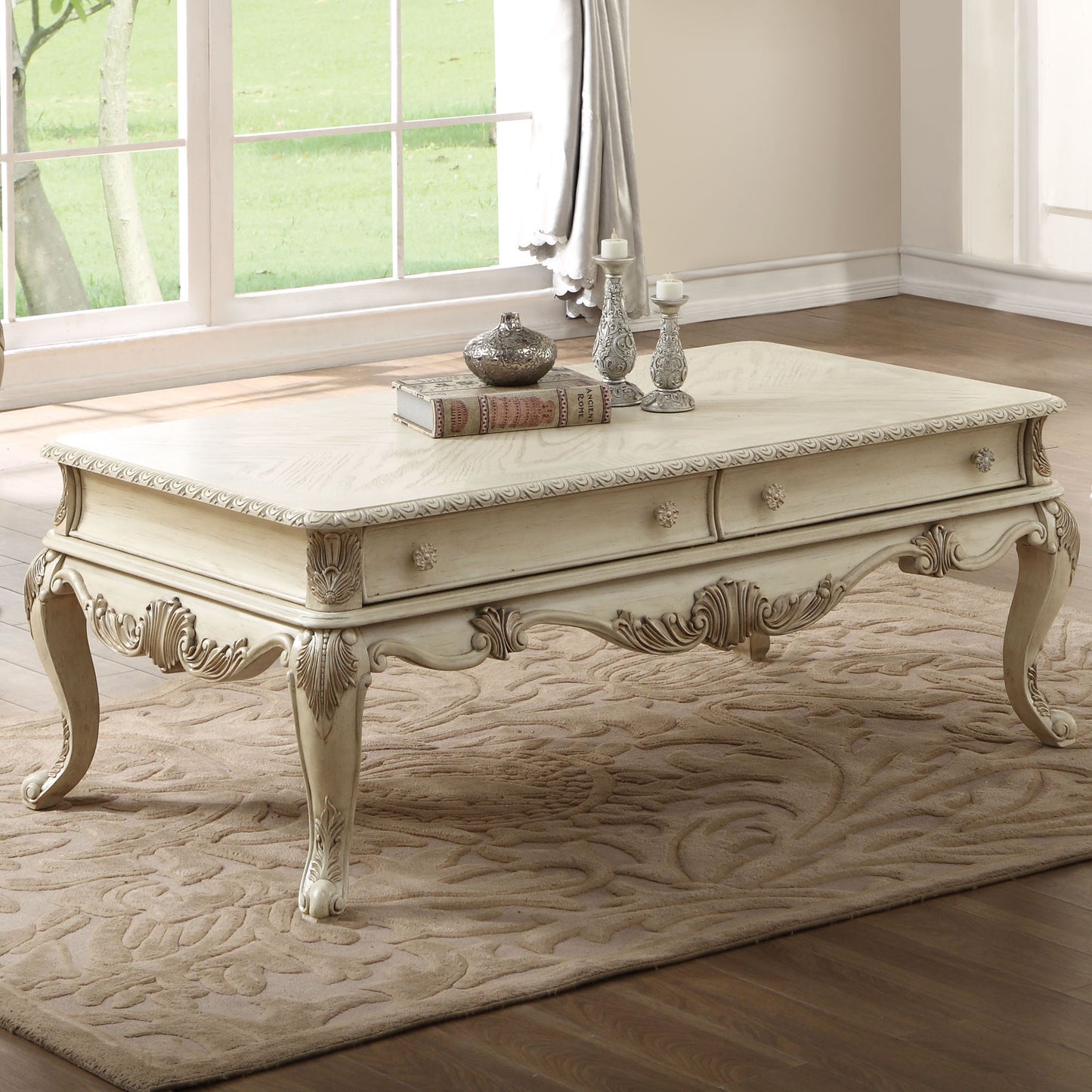 Antique white ornate coffee table with carved details and drawers