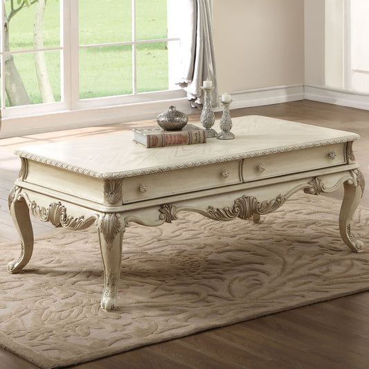 Antique white ornate coffee table with carved details and drawers