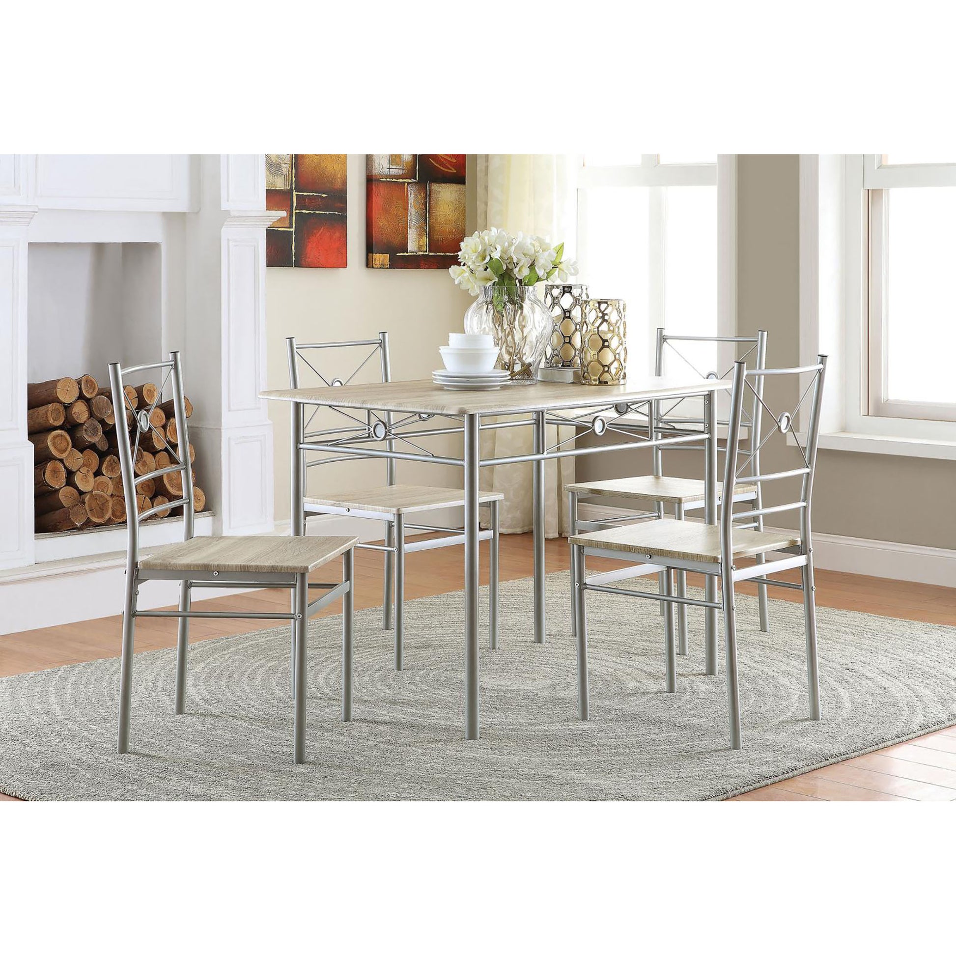 Modern dining set with four silver metal chairs and a light wood grain tabletop perfect for small kitchens