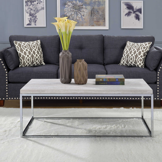 Grey upholstered sofa with decorative nailhead trim and patterned throw pillows