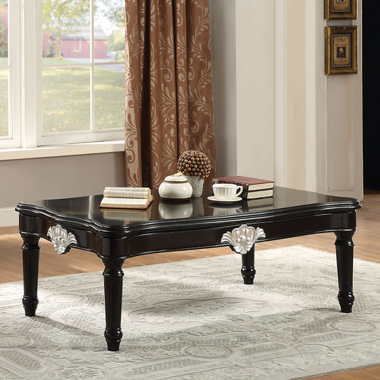 Elegant black rectangular coffee table with ornate silver hardware and carved legs