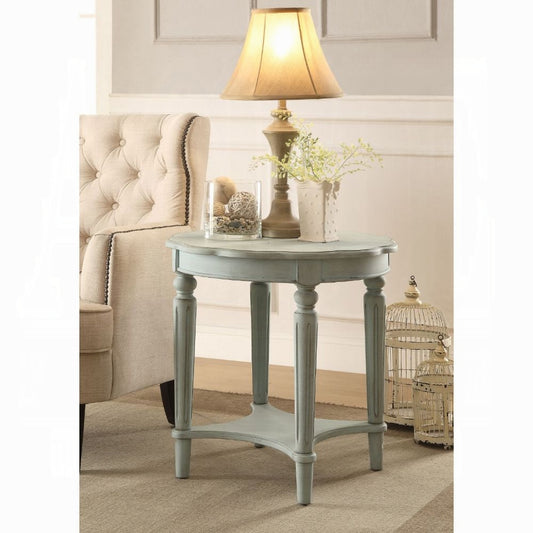 Light blue distressed accent table with turned legs and decorative top edge