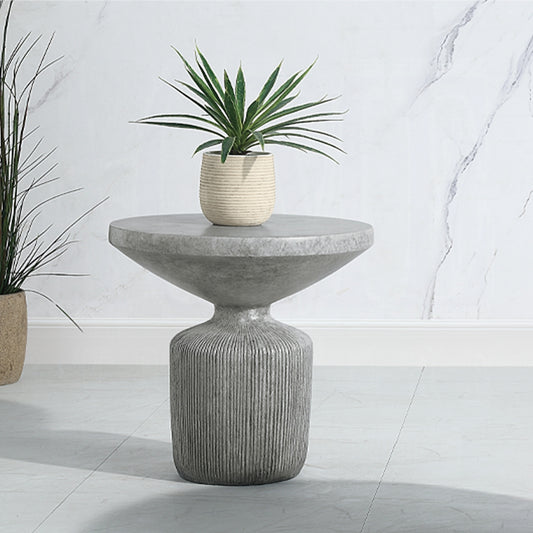 Modern grey concrete end table with ribbed base and plant