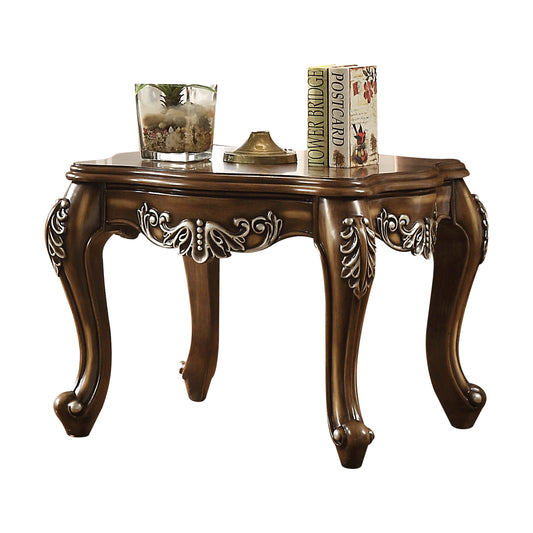 Ornate dark wood accent table with carved details and cabriole legs