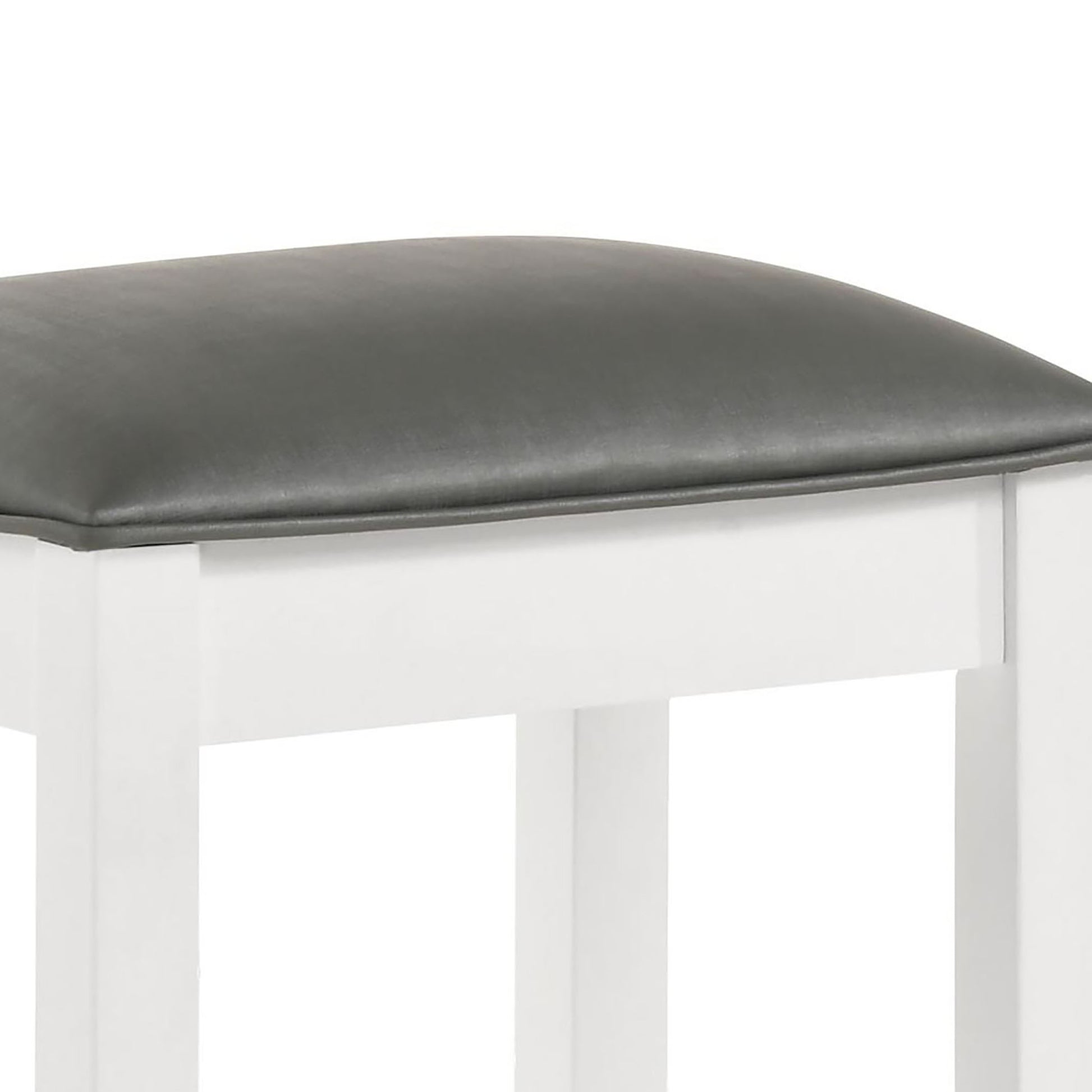 Closeup of a padded gray seat cushion on a white stool frame