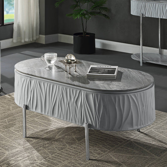 Oval coffee table with grey marble top and textured grey base with chrome legs