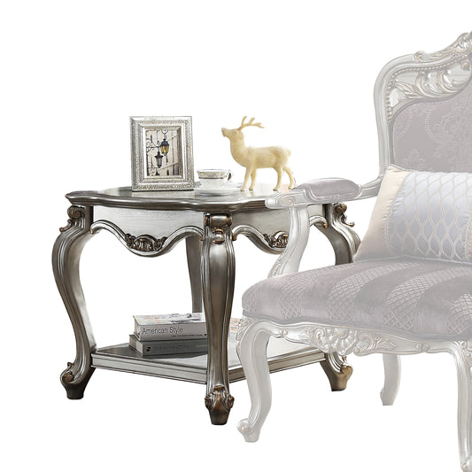 Antique silver ornate end table with carved legs and a lower shelf