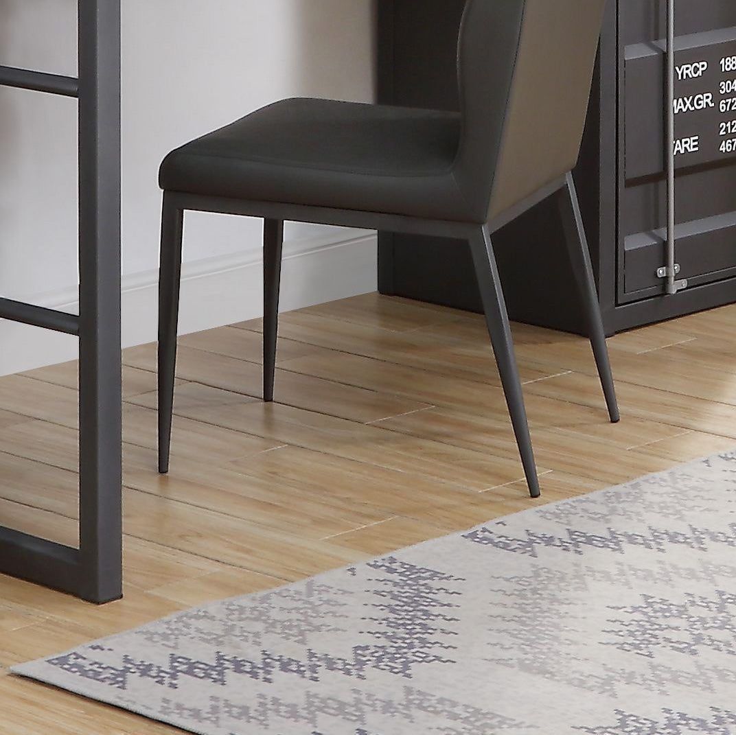 Modern dark grey upholstered dining chair with slender metal legs on a wood floor