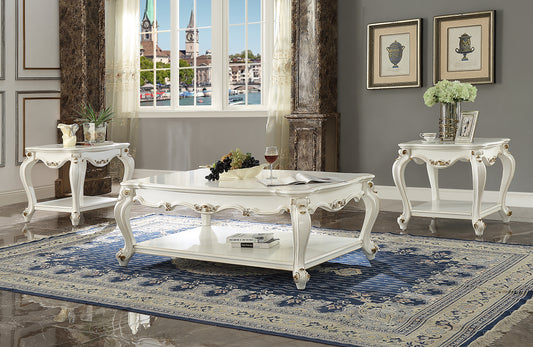 White ornate coffee table with gold accents and decorative legs