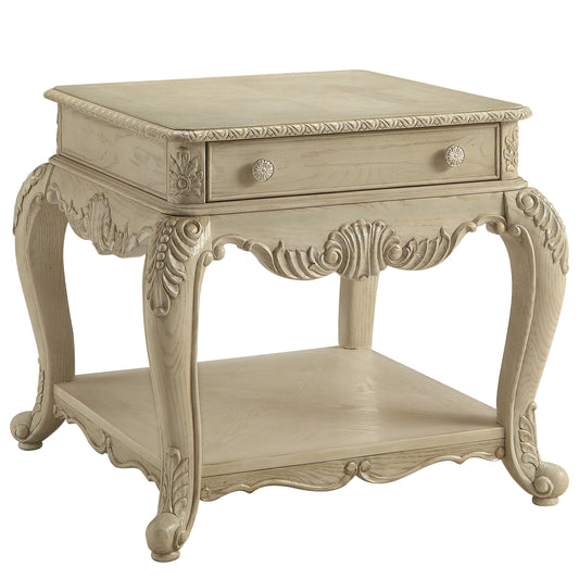 Elegant antique white end table with ornate carved details and single drawer