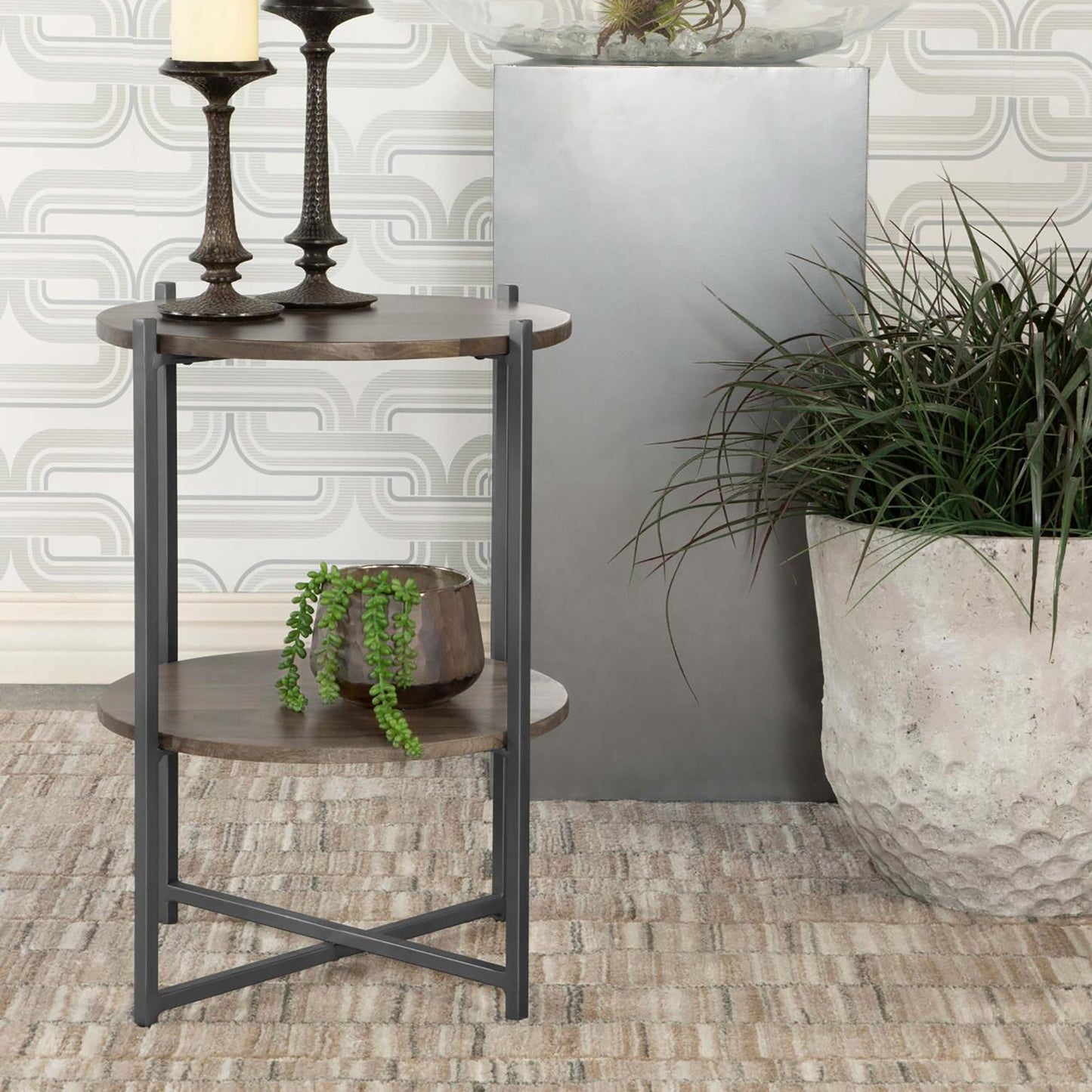 Round wood end table with dark metal frame and two shelves showcasing a modern farmhouse style