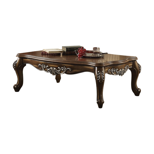 Ornate dark wood coffee table with carved cabriole legs and silver inlay