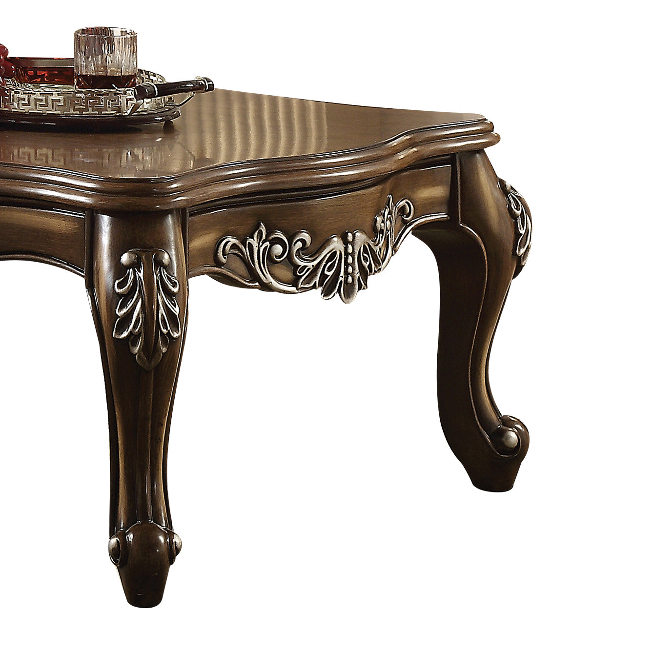 Ornate dark wood coffee table with carved details and cabriole legs
