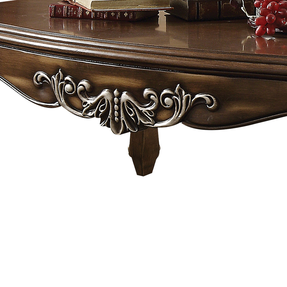 Ornate wooden coffee table with carved details and antique finish
