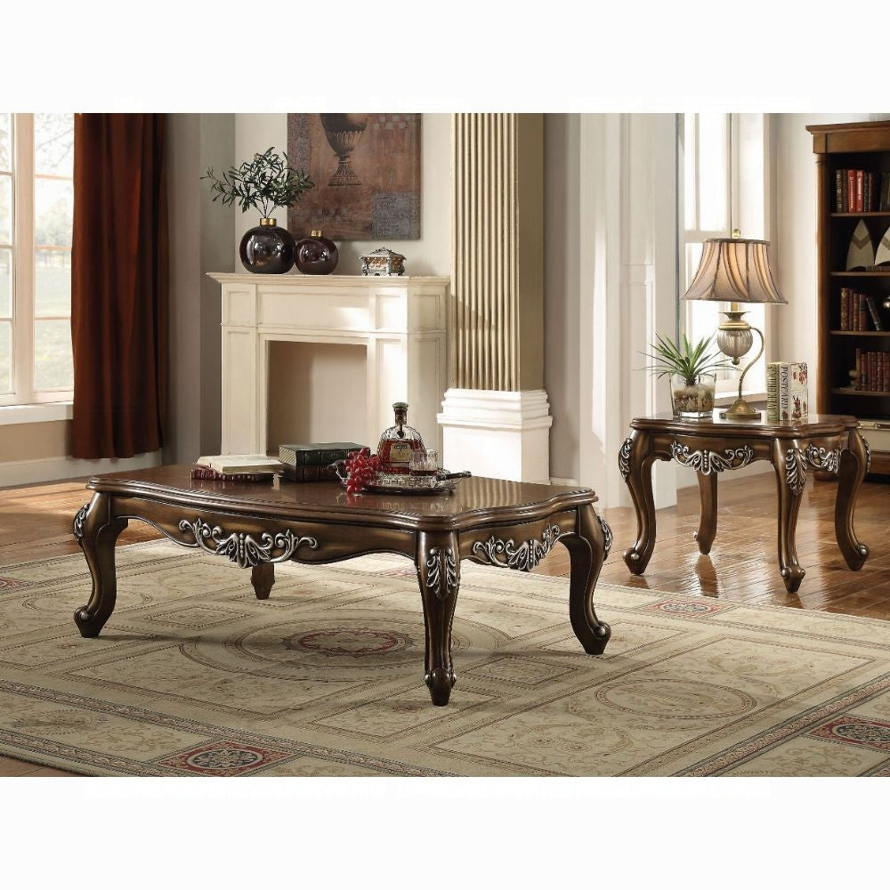Antique brown ornate coffee table with intricate carvings and curved legs ideal for a living room