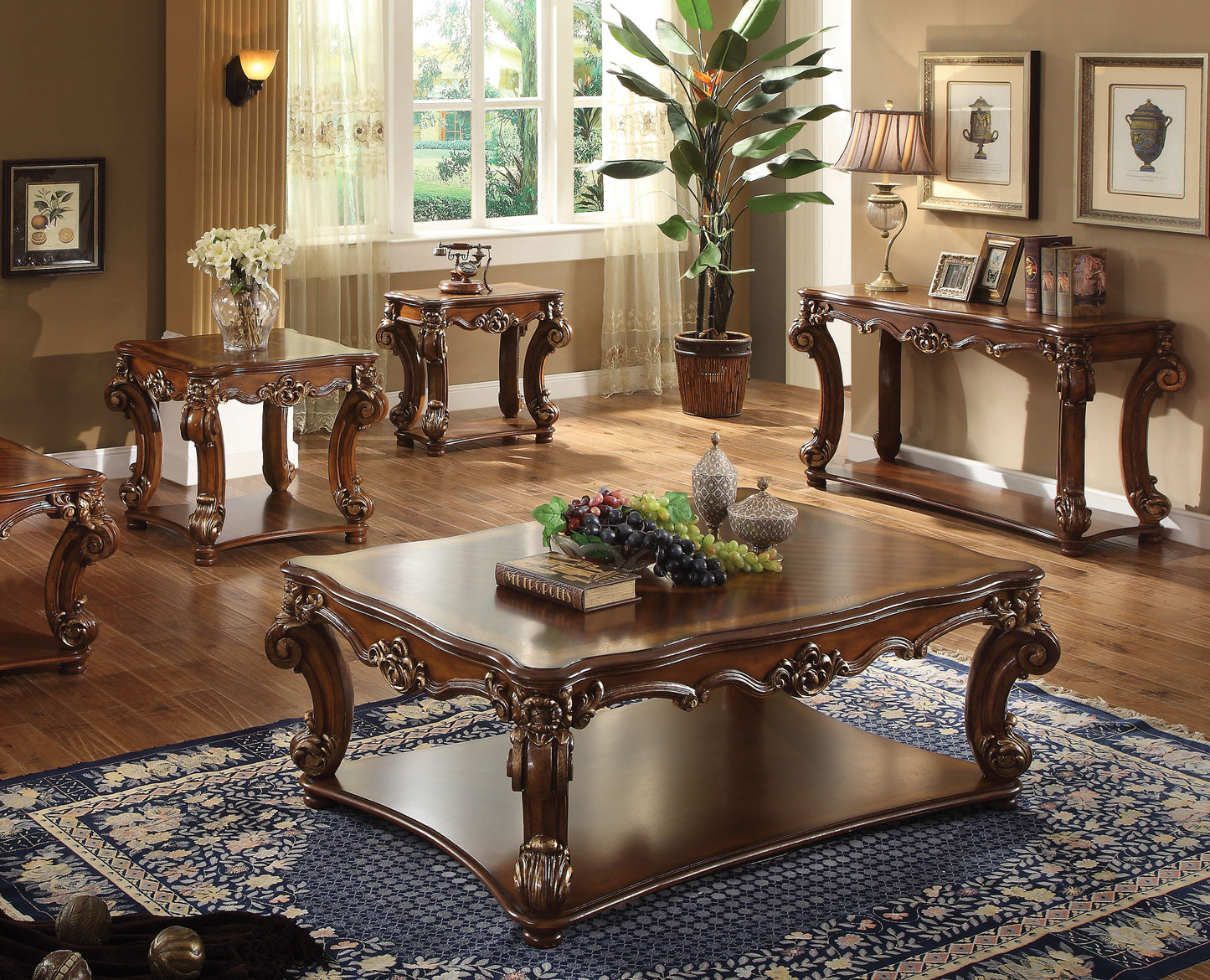Ornate mahogany coffee table with intricately carved legs and a spacious lower shelf