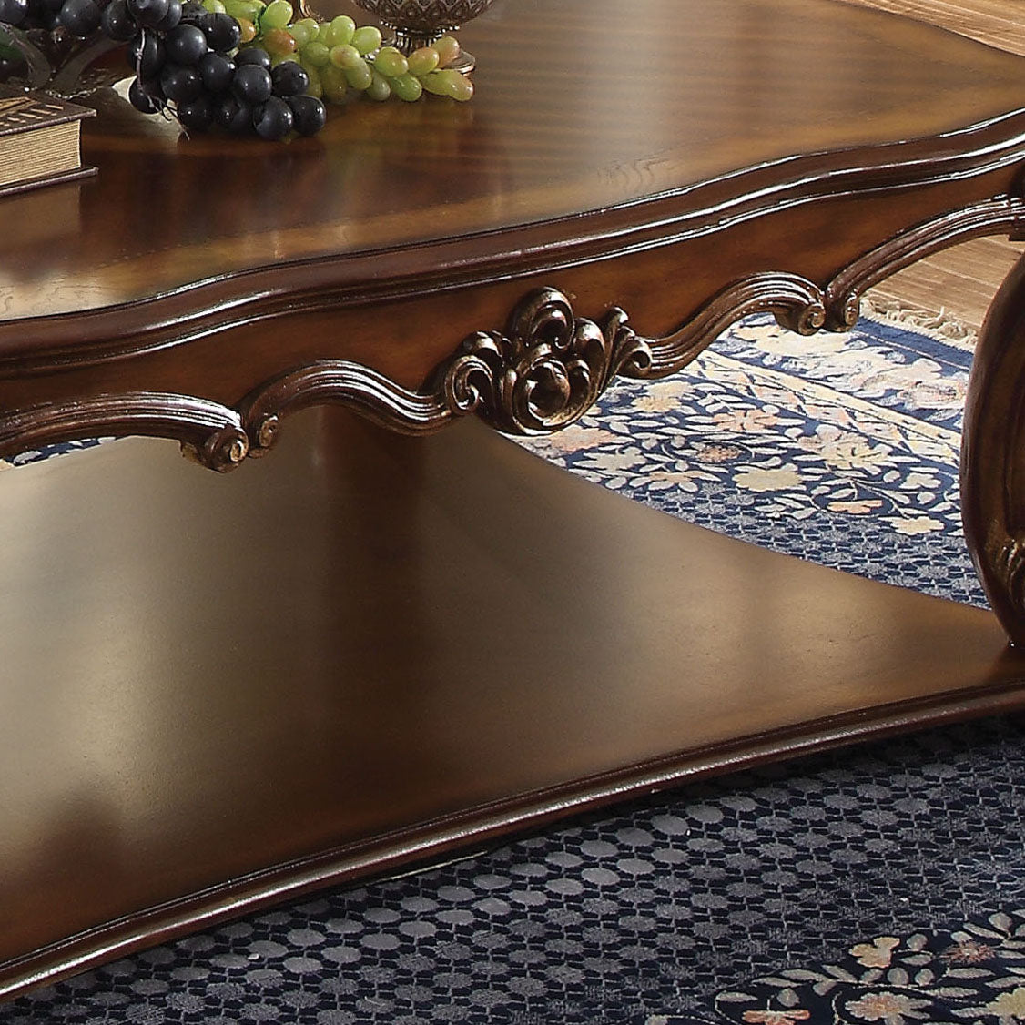Ornate carved mahogany coffee table with a dark wood finish and intricate detailing