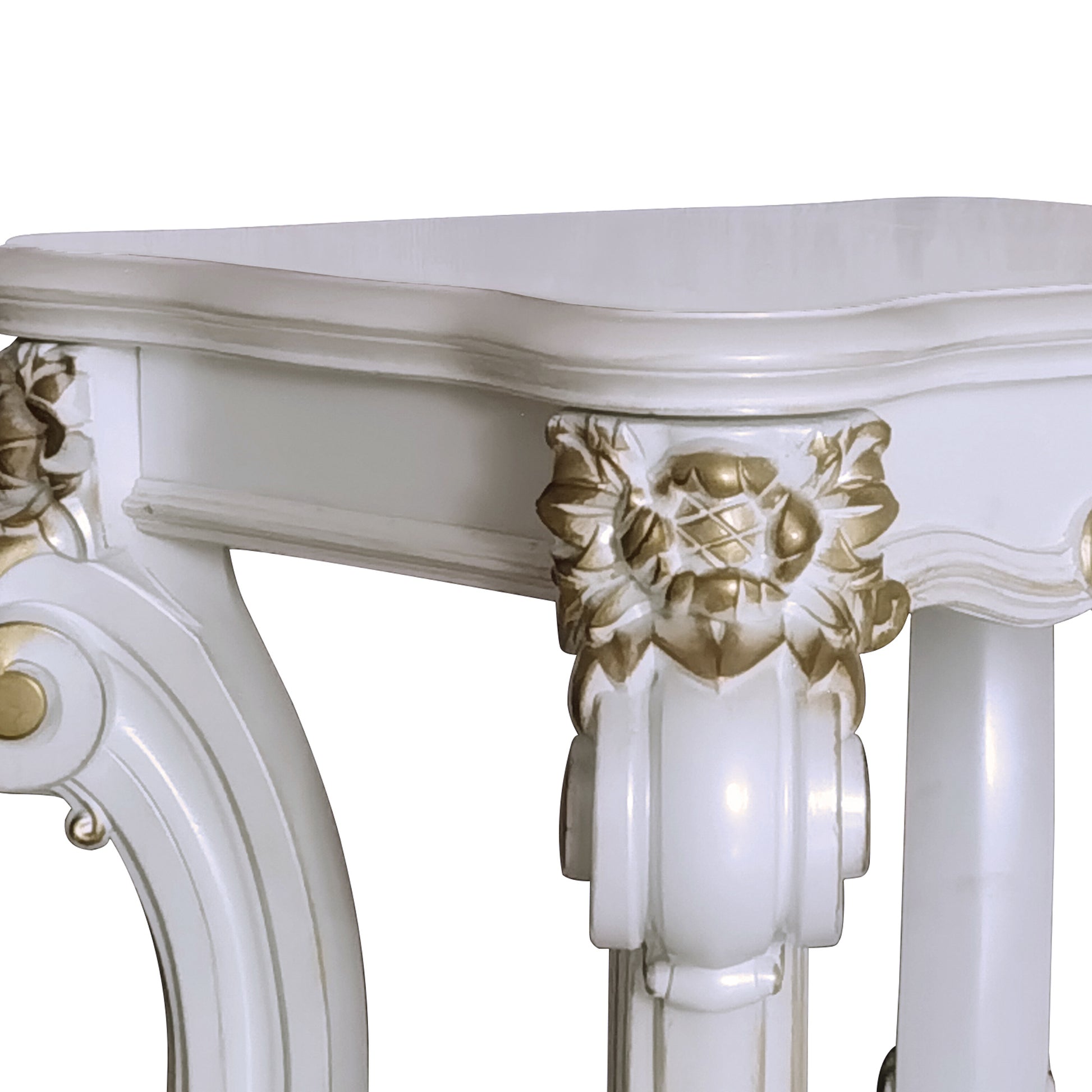 White carved wood console table with ornate gold accents