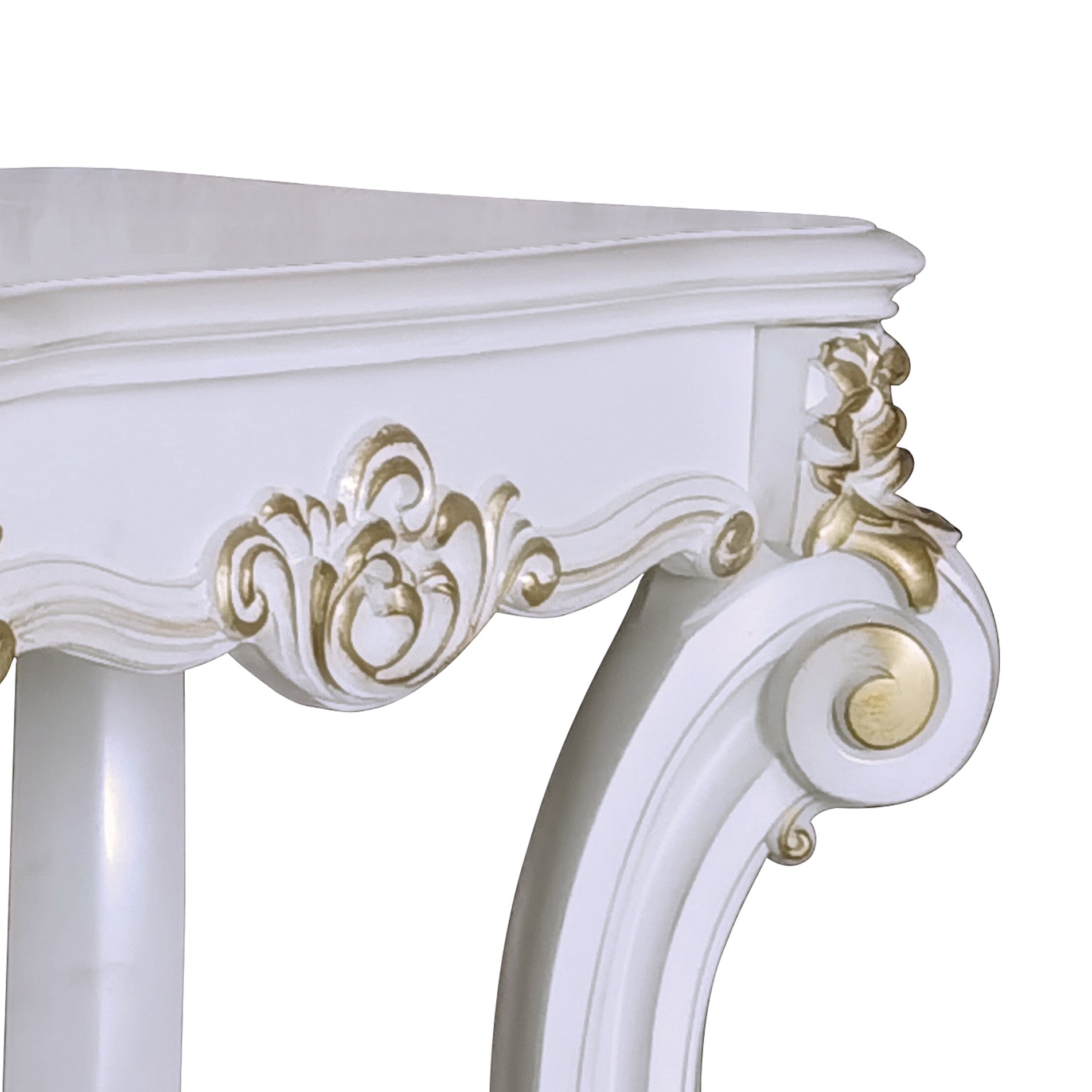 White ornate console table detail with gold accents