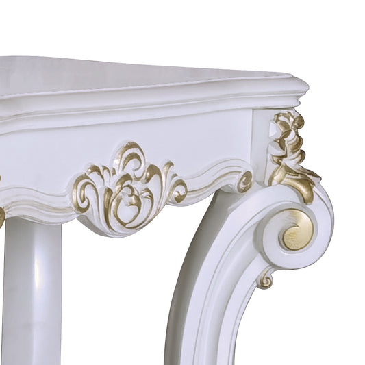 White ornate console table detail with gold accents