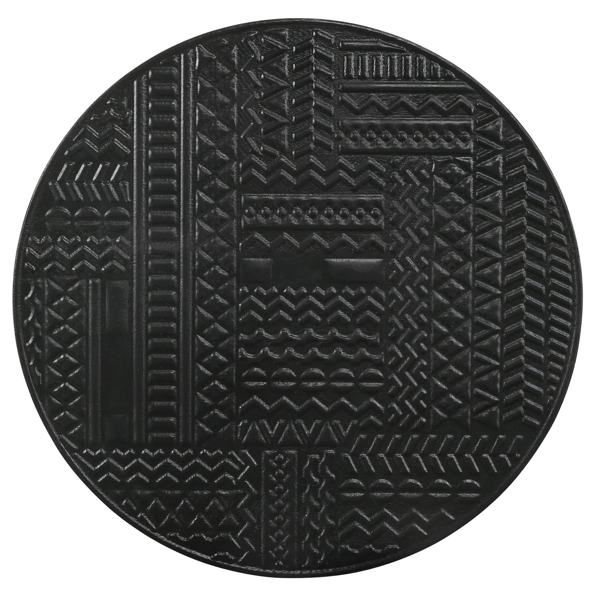Black circular coaster with embossed geometric tribal patterns and intricate textures