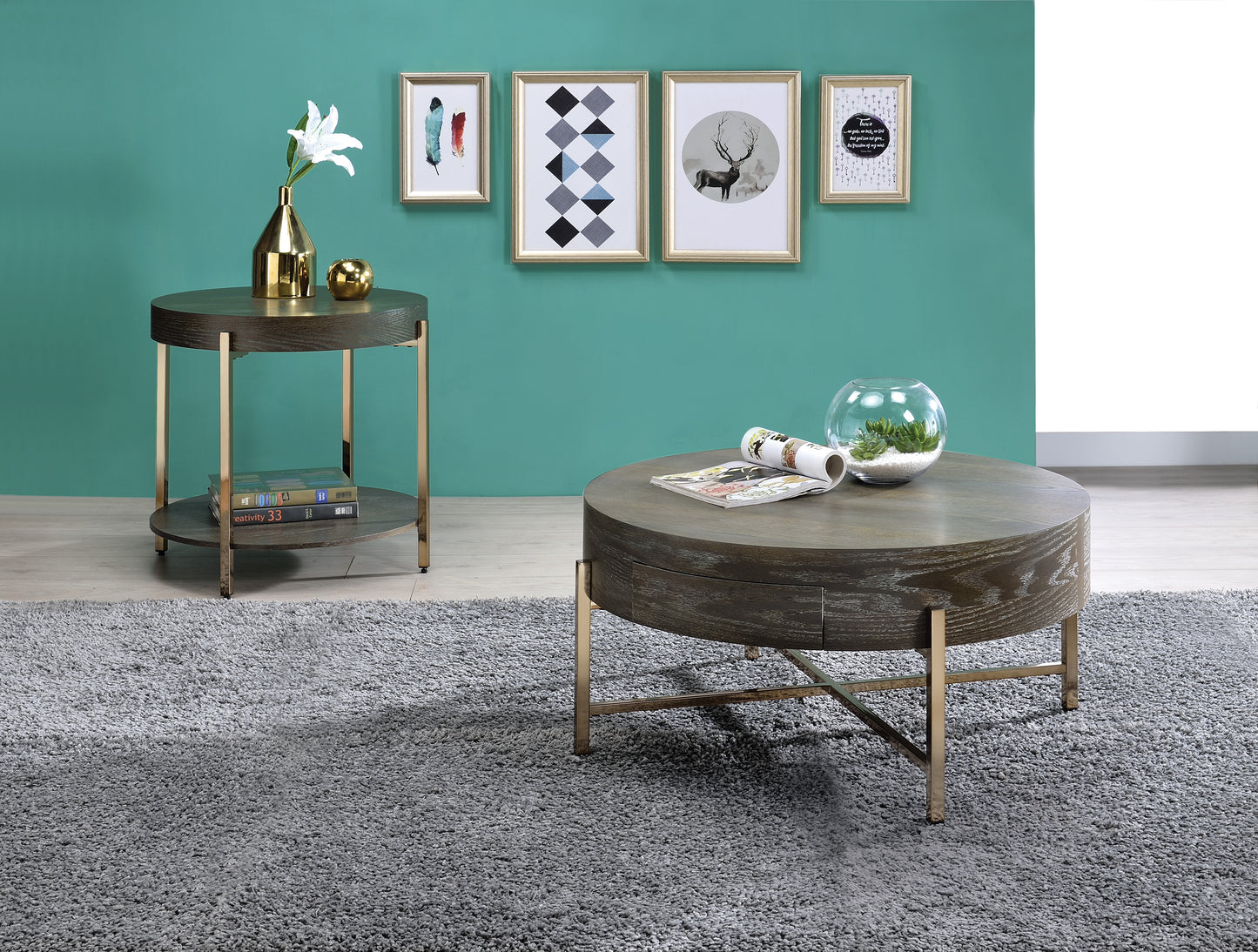 Dark wood round coffee table with gold legs featuring a glass terrarium with succulents