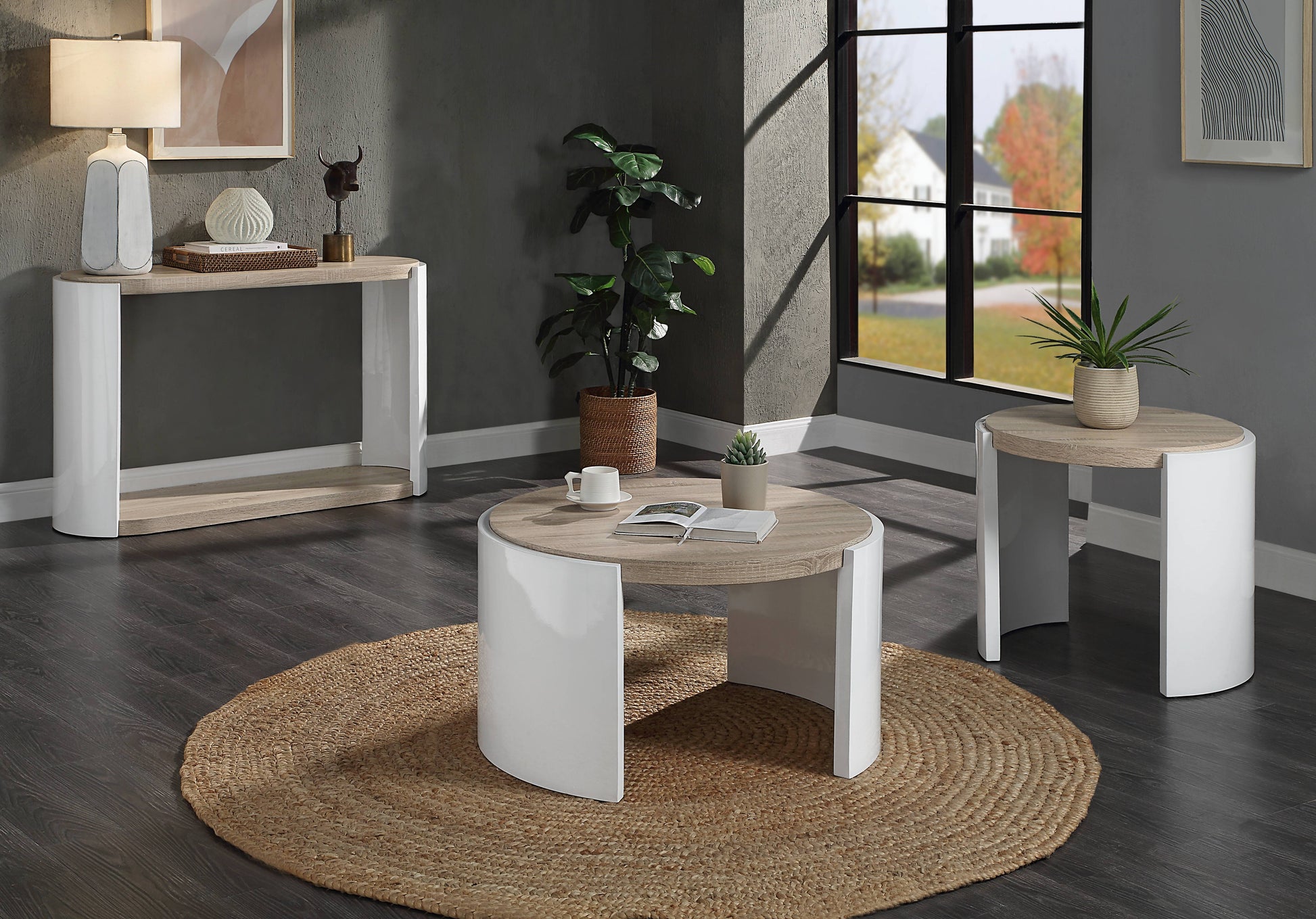 Modern white and wood coffee table with a circular braided jute rug and a stack of books