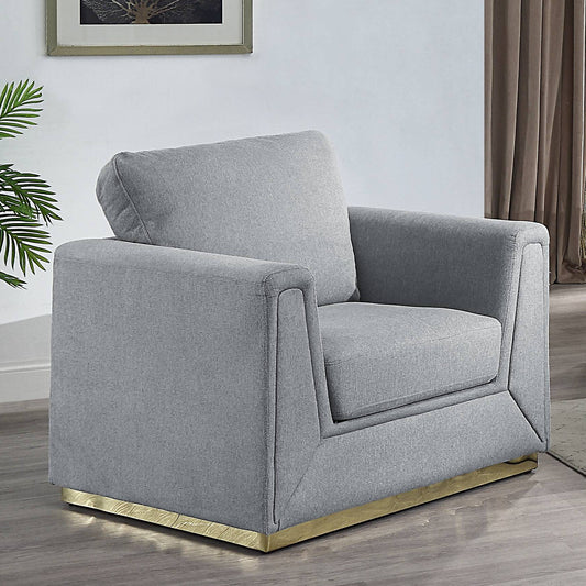Gray fabric armchair with modern gold base and plush cushion