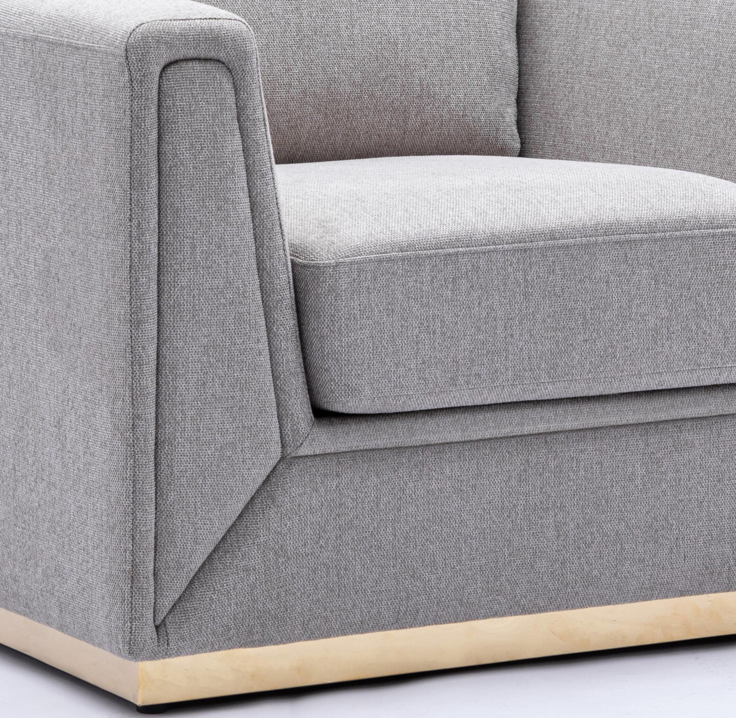Textured grey fabric armchair with a modern goldtone base
