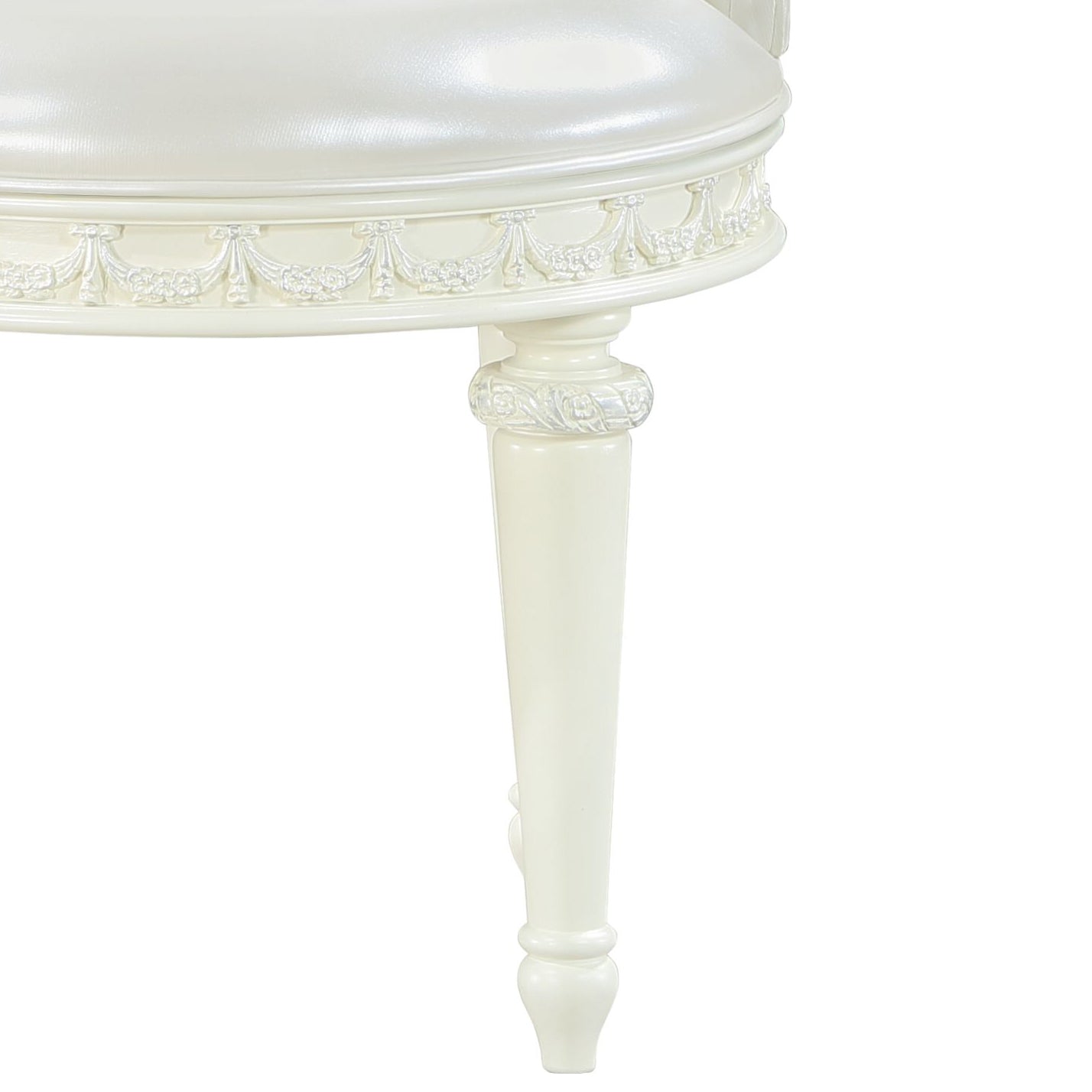 Cream upholstered vanity stool with carved trim and tapered leg