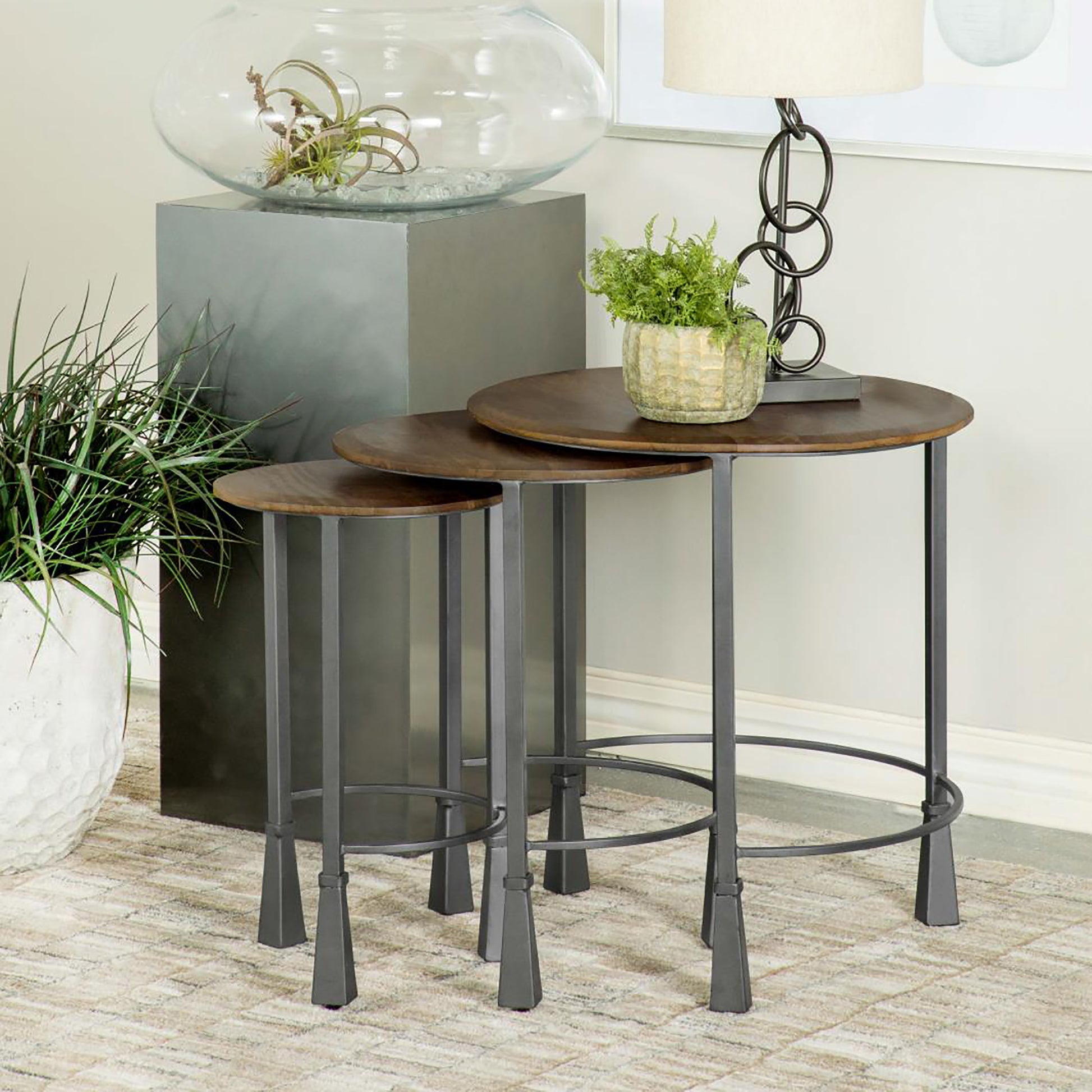 Set of  round wood top nesting tables with dark gray metal frames perfect for modern living rooms