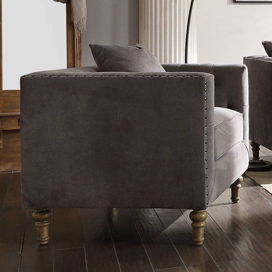 Dark grey velvet armchair with tufted details and nailhead trim