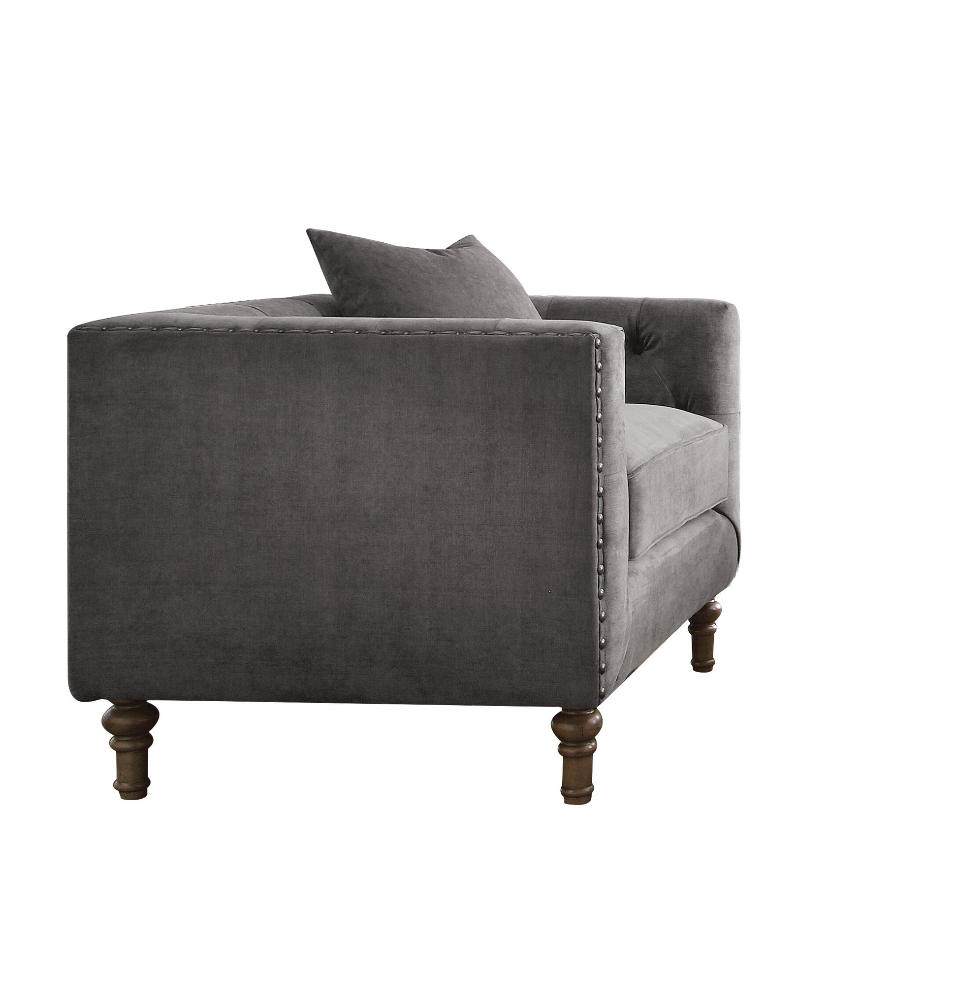 Dark gray velvet armchair with tufted back and nailhead trim accent
