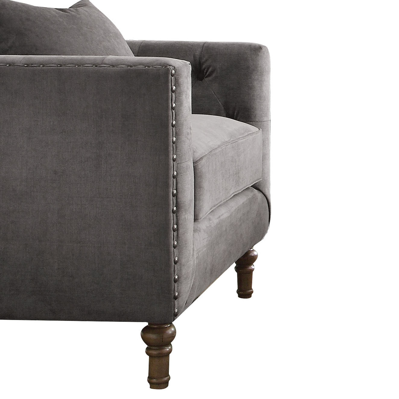 Tufted grey velvet armchair with decorative nailhead trim and wooden legs
