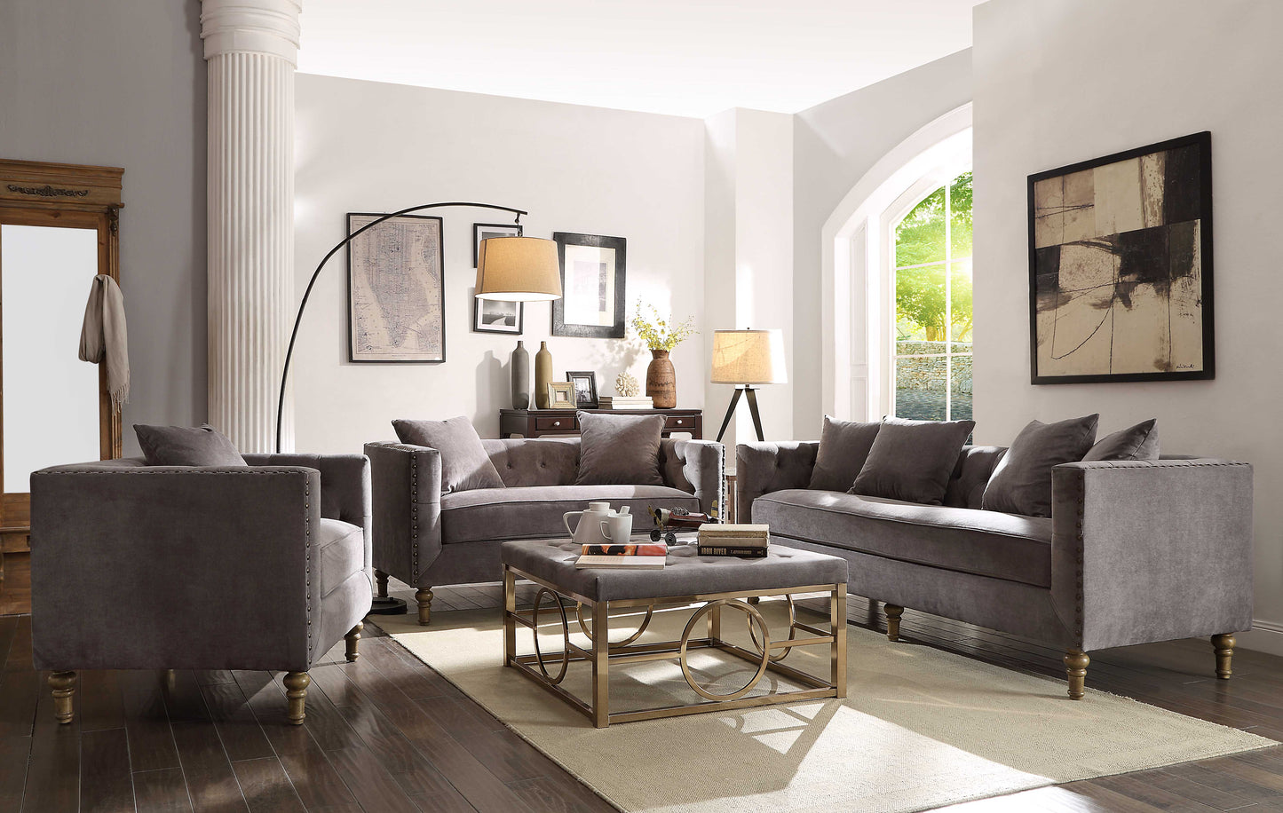 Dark gray velvet sofa with tufted back and silver nailhead trim detail