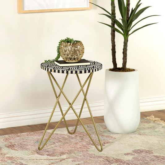 Round side table with black and white geometric inlay top and gold hairpin legs