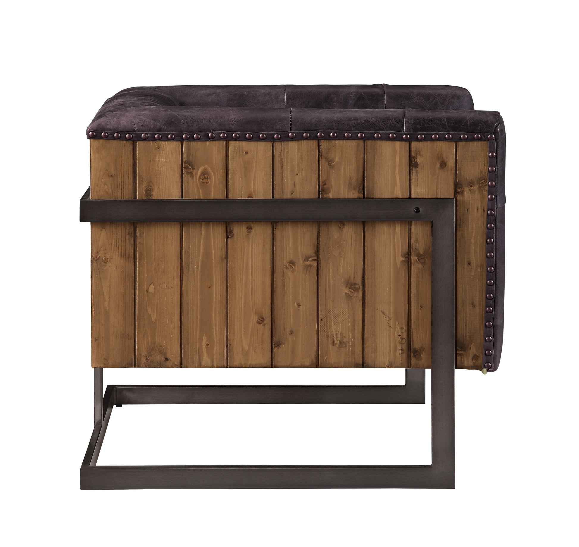 Dark brown tufted armchair with studded distressed leather and reclaimed wood siding