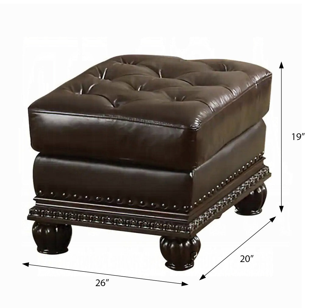 Dark brown tufted leather ottoman with ornate carved base and decorative nailhead trim
