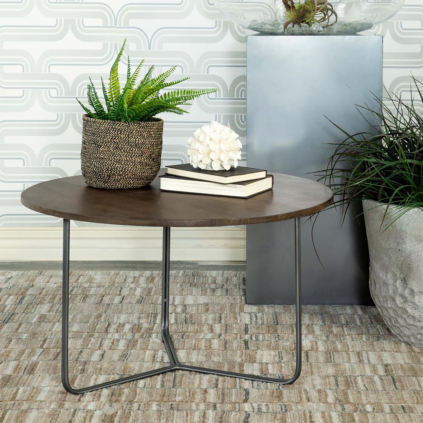 Round dark wood coffee table with modern black metal legs