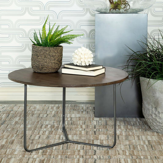 Round dark wood coffee table with modern black metal legs