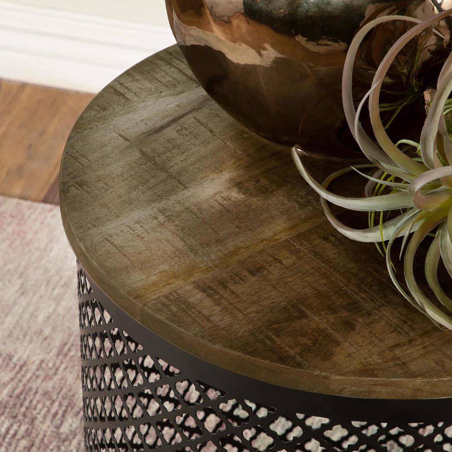 Round reclaimed wood side table with intricate metal lattice base