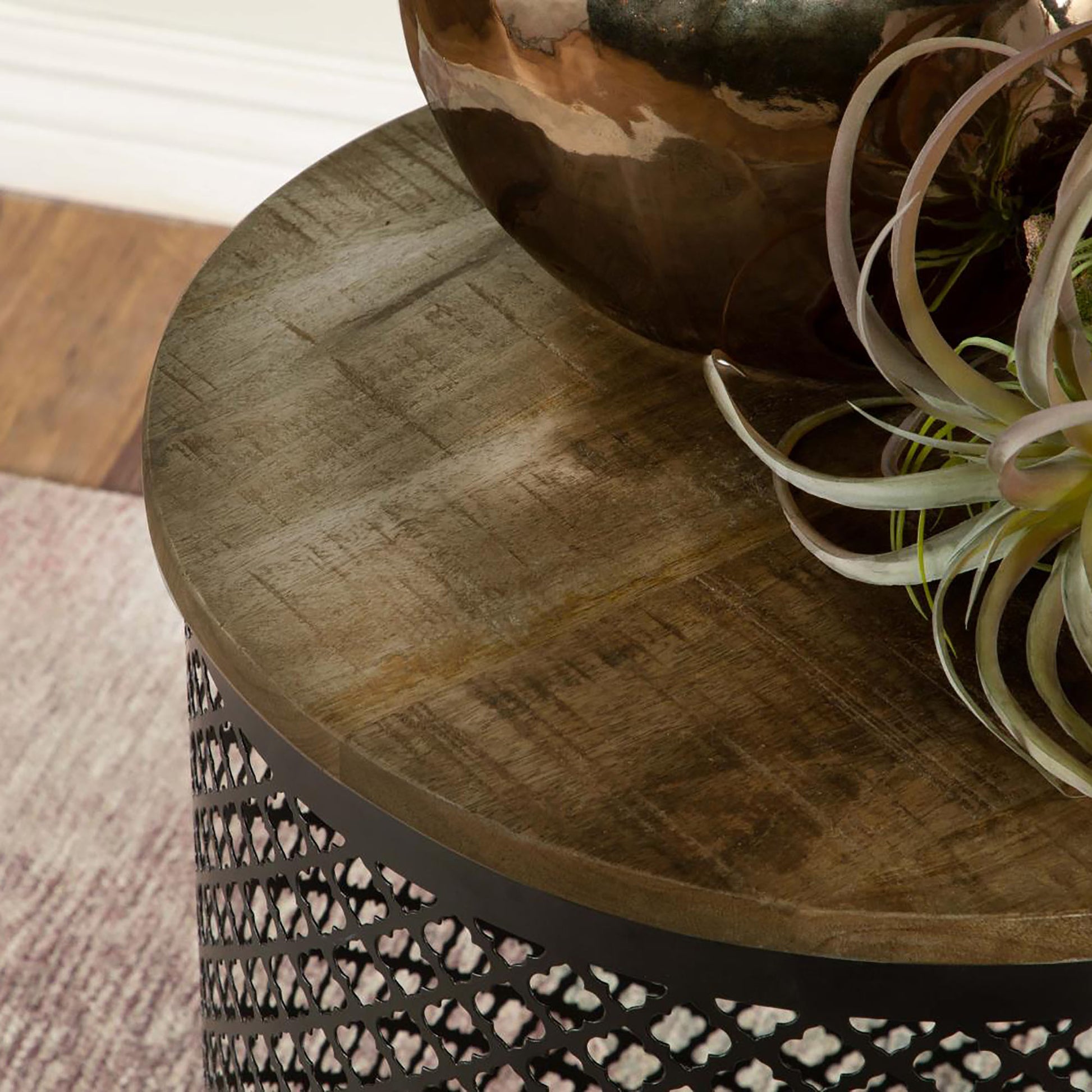 Round reclaimed wood side table with intricate metal lattice base