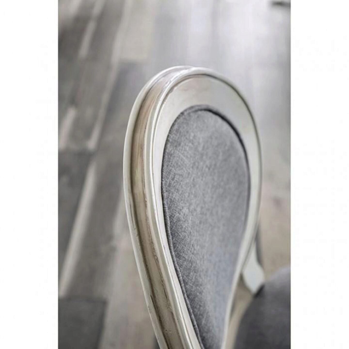 Upholstered grey dining chair with carved wooden frame